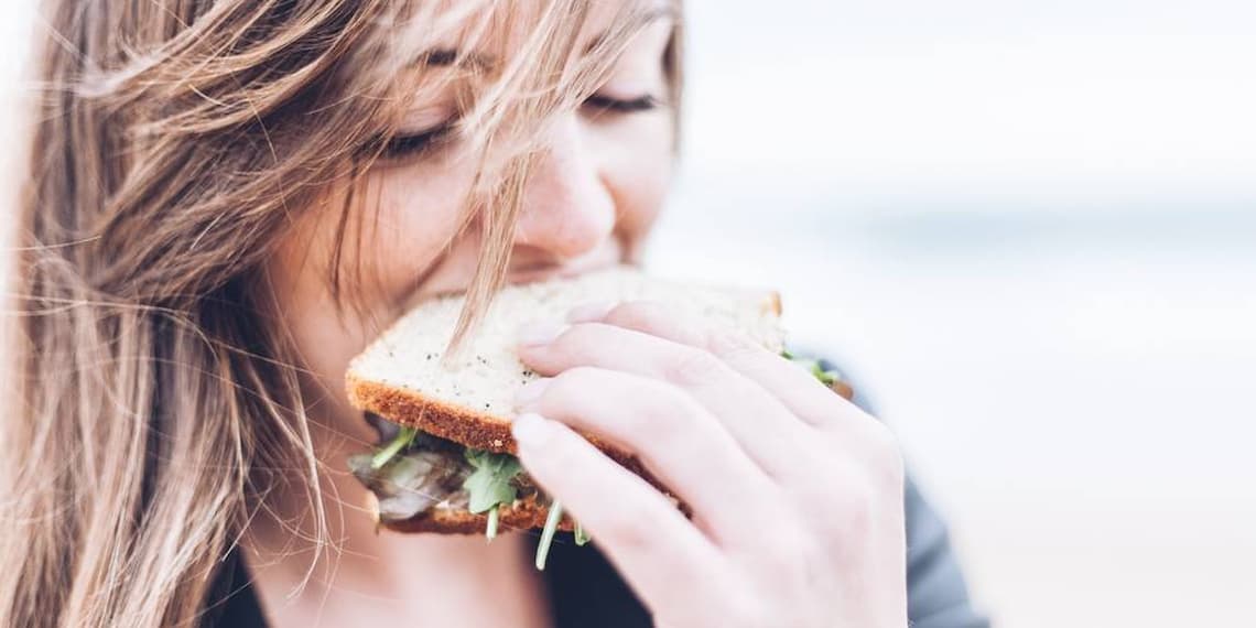 Woman eating sandwich